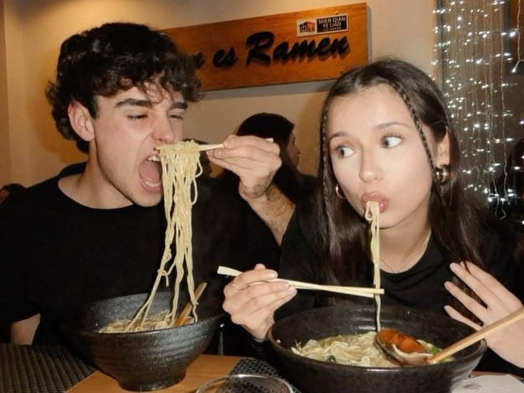 a couple sharing ramen at a counter
